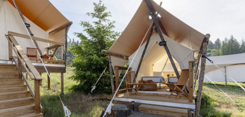 Under Canvas Kids Tent with two twin beds, a wooden deck and outdoor chairs.