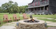 Star House at Wander Inn in Round Top with an outdoor stone fire pit and Adirondack chairs.