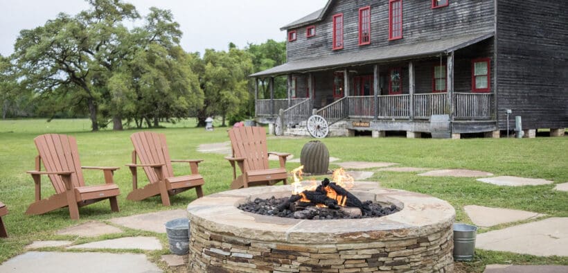 Star House at Wander Inn in Round Top with an outdoor stone fire pit and Adirondack chairs.