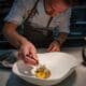 Chef Drew Anderson carefully plates a dish in the kitchen at Kai in Chandler, Arizona.
