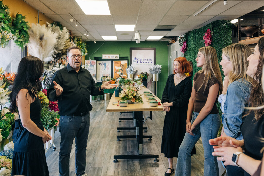 Eric Luoma speaks with guests inside Cactus Flower Florists in Scottsdale.