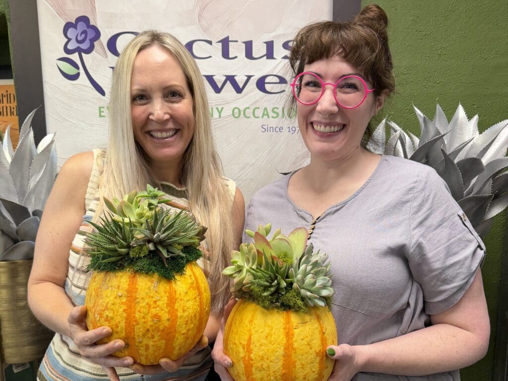 Erin Thorburn and Emily Hooper hold succulent-topped pumpkins after a class at Cactus Flower Florists in Scottsdale.