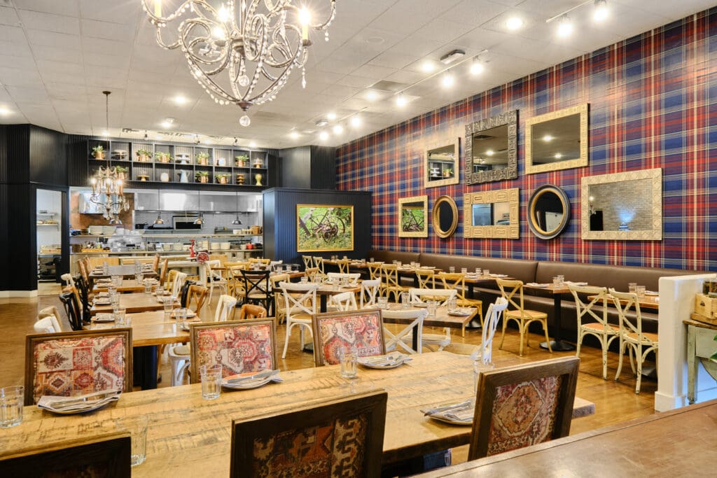 Honey Salt dining room with an open kitchen, navy walls and wood tables in Las Vegas.