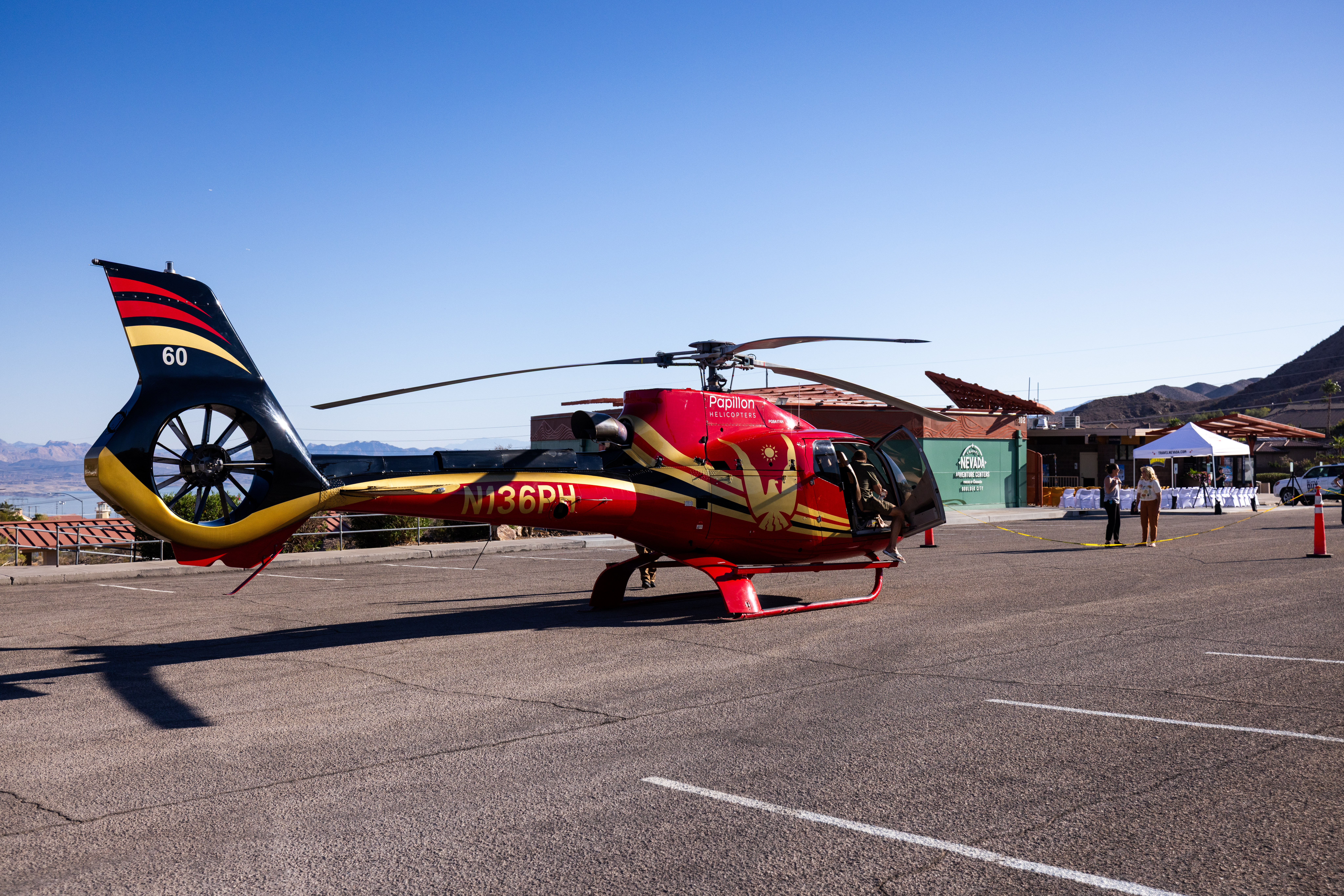 Red and yellow Papillon helicopter parked outside the Travel Nevada Adventure Center in Boulder City.