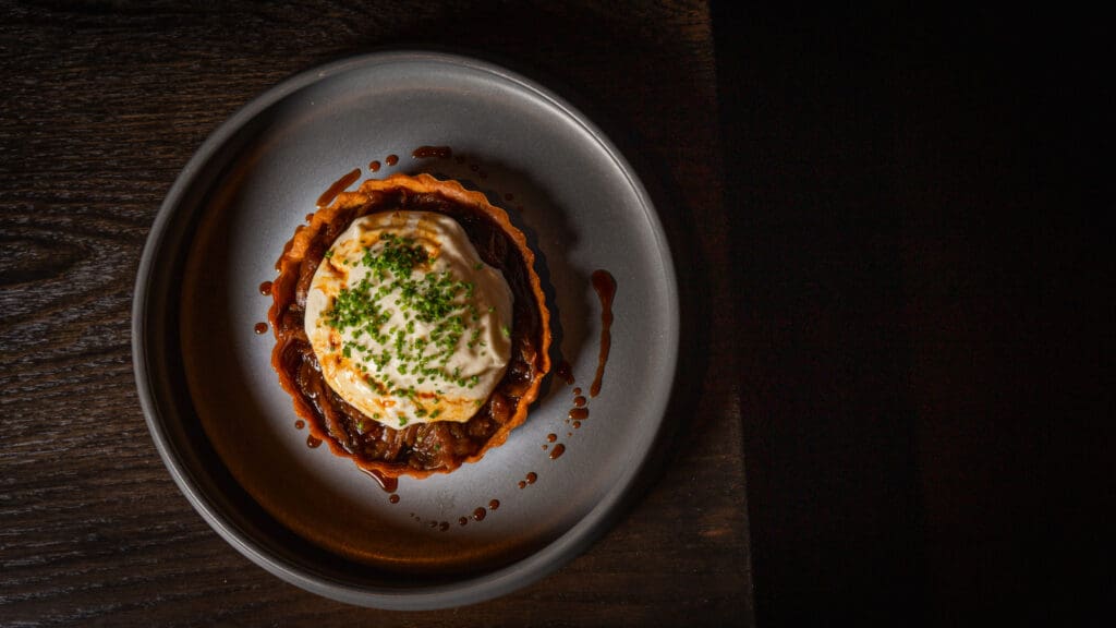 French Onion Tartlet with caramelized onions and Taleggio fondue at BearLeek.