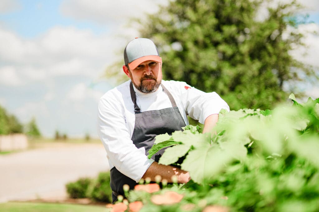 Chef David Rule gathering fresh produce outdoors in West Texas.