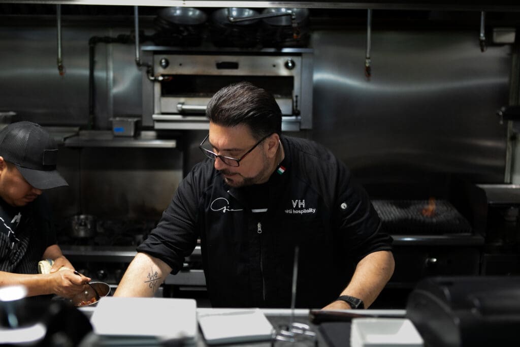 Chef Gio Osso working with his culinary team in the Virtù Honest Craft kitchen.