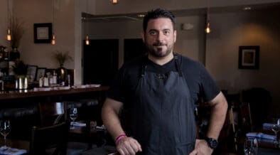 Chef Gio Osso standing inside Virtù Honest Craft in Scottsdale.