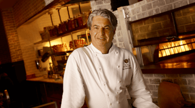 Chef Kim Canteenwalla stands inside a restaurant kitchen in Las Vegas.