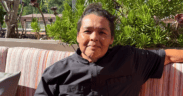 Chef Linda Garcia seated on the rooftop terrace at Topside Terrace Kitchen & Bar in San Diego