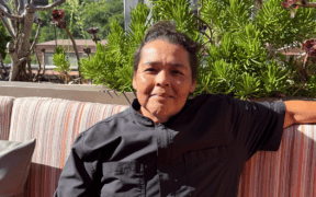 Chef Linda Garcia seated on the rooftop terrace at Topside Terrace Kitchen & Bar in San Diego