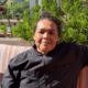 Chef Linda Garcia seated on the rooftop terrace at Topside Terrace Kitchen & Bar in San Diego