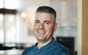 Chef Nick Zocco wearing a blue Urban Hill chef’s coat in Salt Lake City