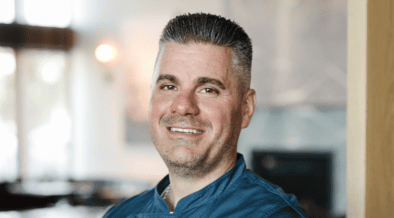 Chef Nick Zocco wearing a blue Urban Hill chef’s coat in Salt Lake City