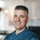 Chef Nick Zocco wearing a blue Urban Hill chef’s coat in Salt Lake City