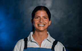 Chef Rema Maaliki wearing a blue apron at BearLeek in Denver.
