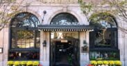 The Culver Hotel façade decorated with skeletons, orange and white pumpkins and yellow flowers around the entrance.