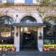 The Culver Hotel façade decorated with skeletons, orange and white pumpkins and yellow flowers around the entrance.