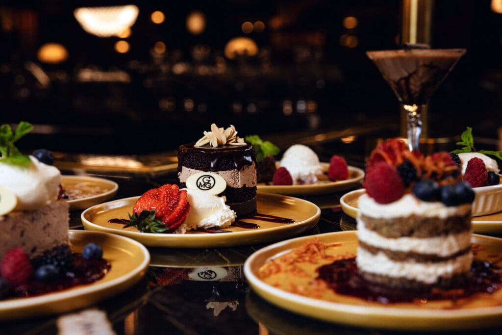 Assortment of plated desserts with berries at Gregory’s Mesquite Grill.