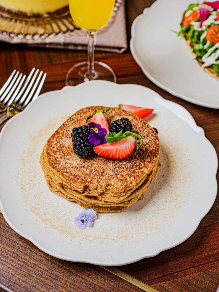 Sopapilla Pancakes topped with strawberries, blackberries and edible flowers at Millie Leigh’s.