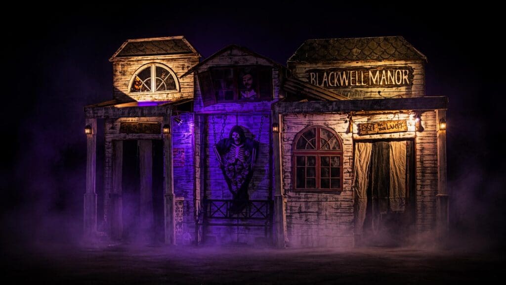 Tom Devlin’s Monster Museum haunted attraction illuminated at night in Boulder City, Nevada.